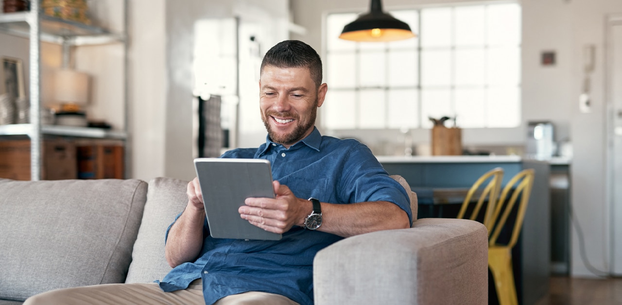 a man sitting in a chair using a laptop
