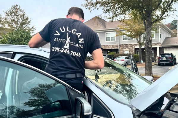 A Man Standing Next To A Car